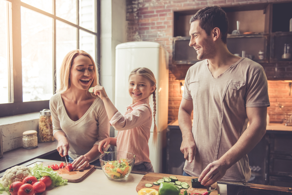 Parents and child preparing healthy meal