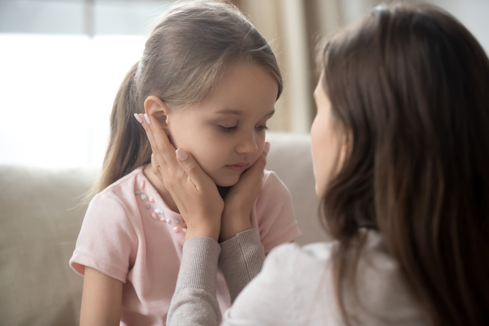A mother comforts a young girl newly diagnosed with childhood diabetes.