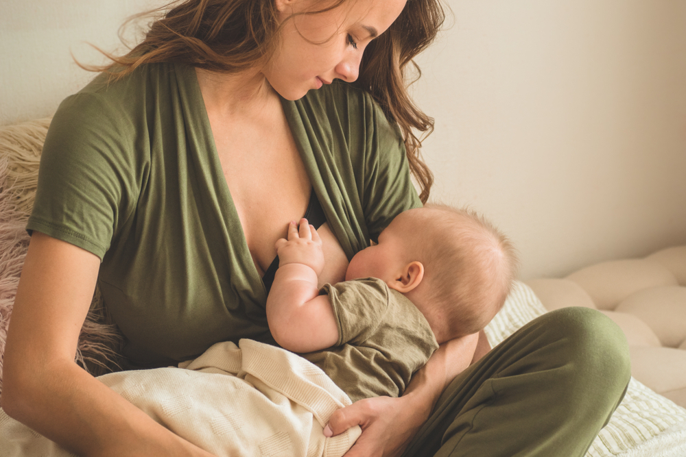 A mother nurses her baby