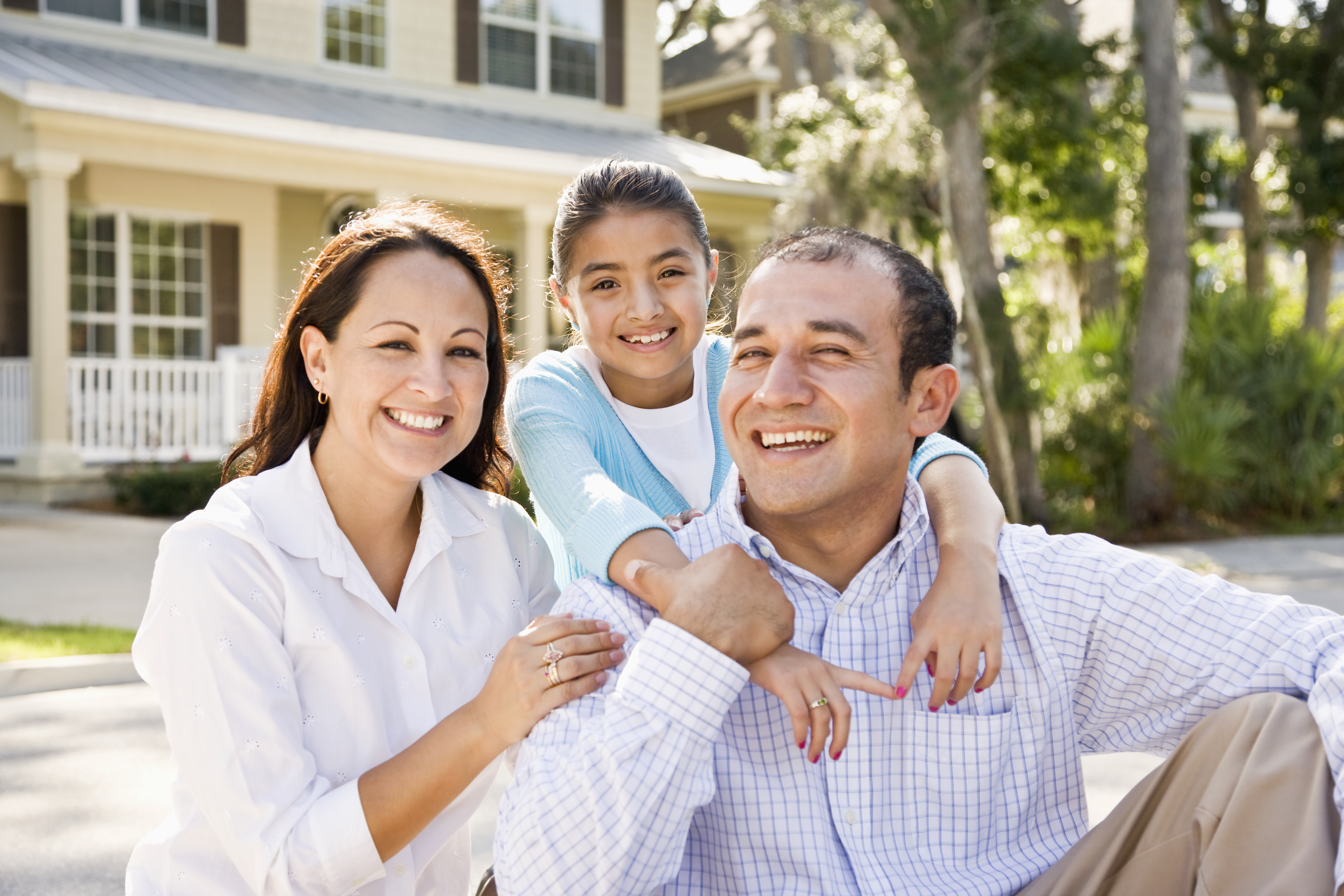 Happy Hispanic family outside